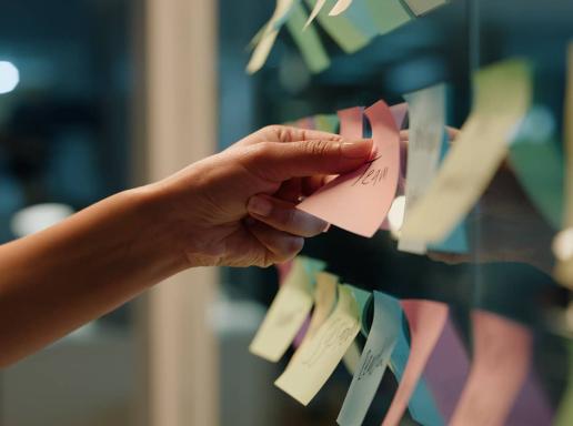 Hand laying out post it notes